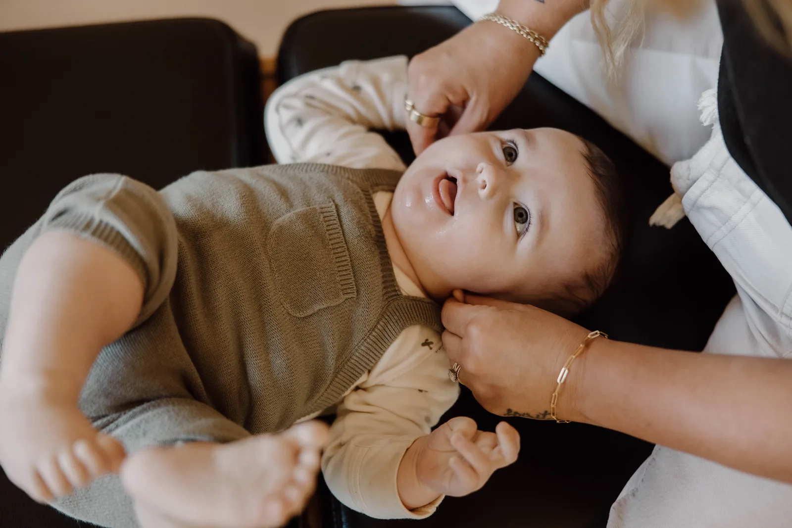 Baby receiving gentle head and neck support during an infant chiropractic visit in Temecula