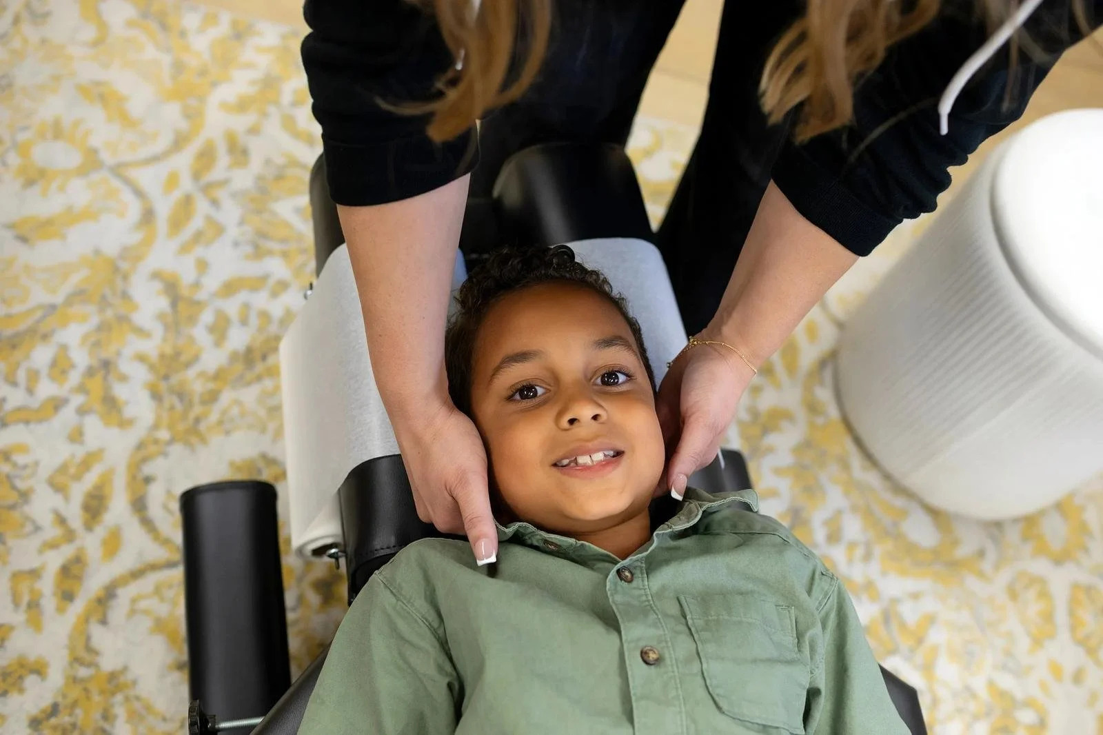 Dr. Jennifer Gordon gently supporting a young boy's head and neck