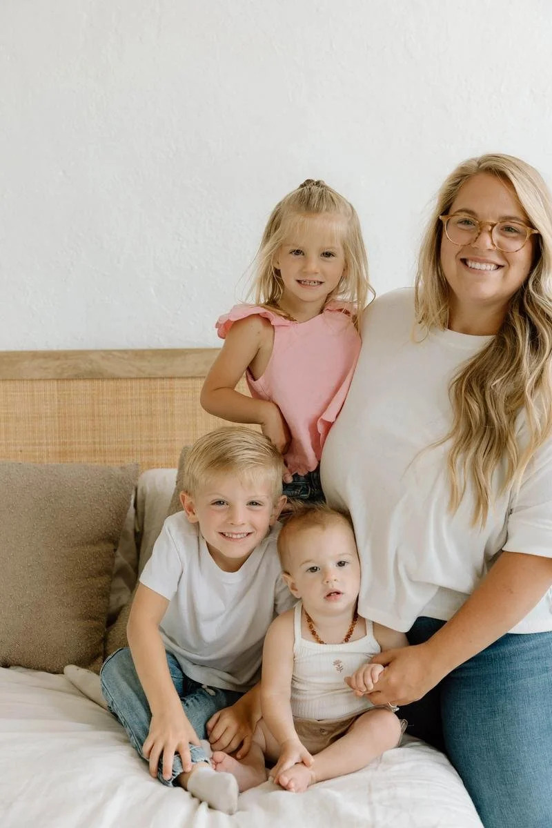 Mother sitting with her three children for a family portrait