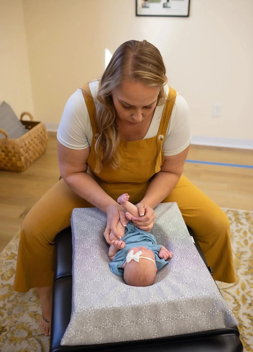 Dr. Jennifer Gordon performing an infant chiropractic adjustment
