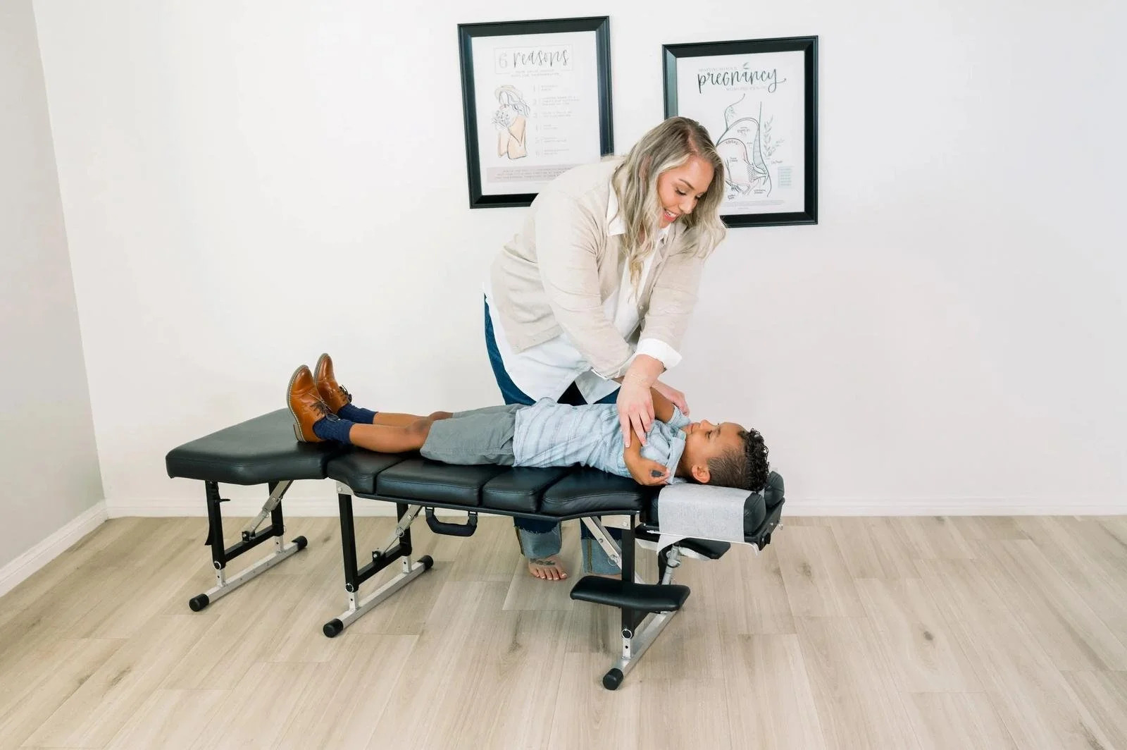 Dr. Jennifer Gordon adjusting a young boy on a treatment table