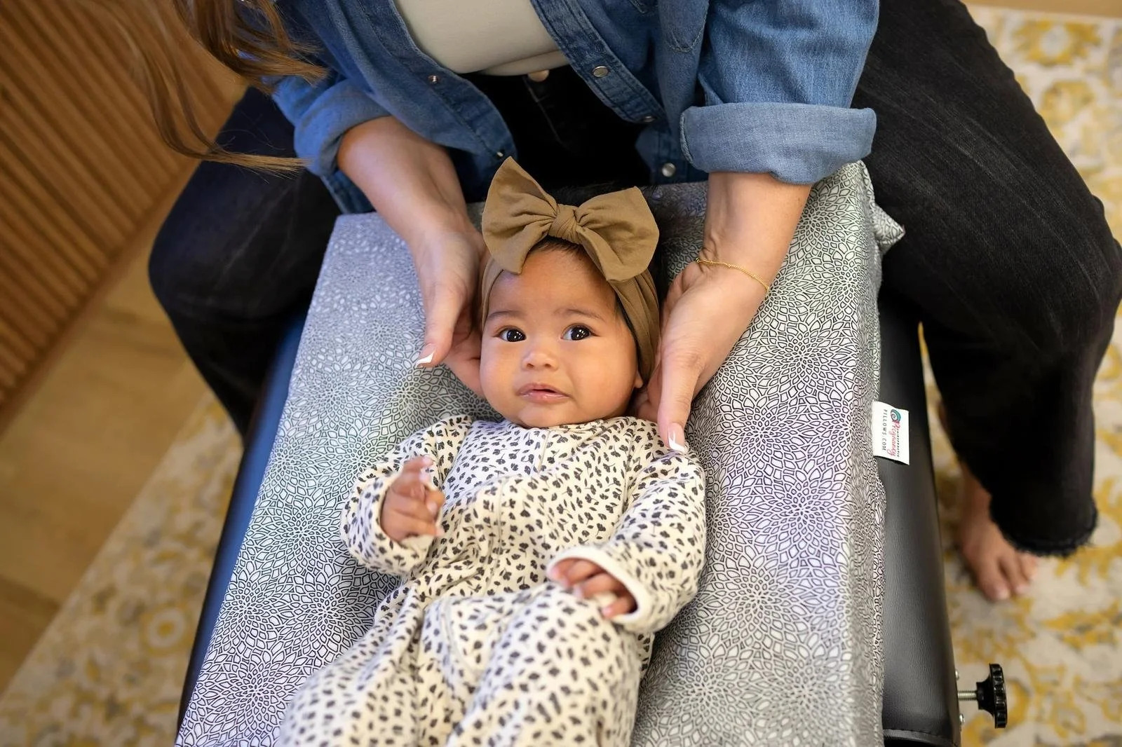 Dr. Jennifer Gordon gently supporting an infant’s head and neck